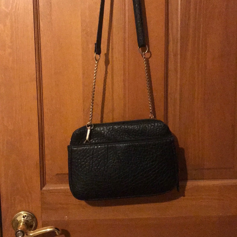 Black cross body bag. Many pockets